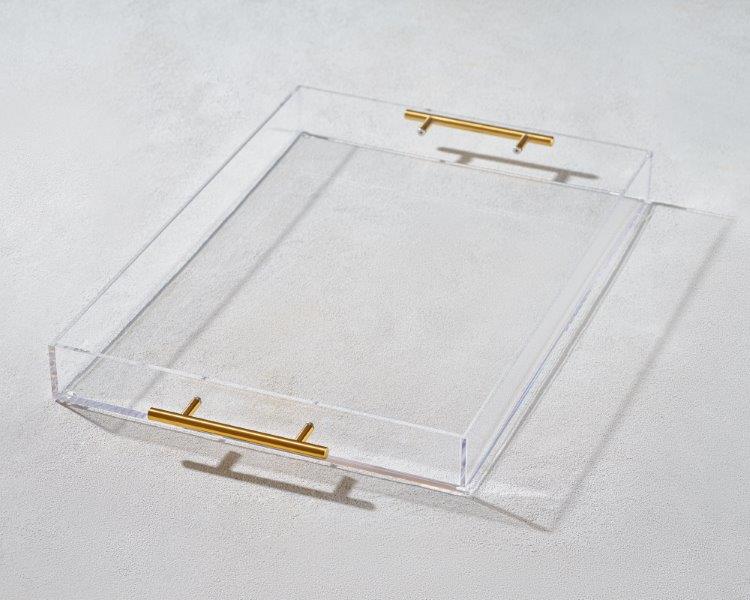 a clear acrylic tray with gold handles